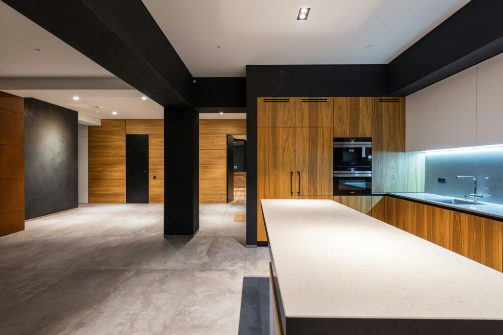 Sleek contemporary kitchen interior with wooden cabinets and minimalist style.